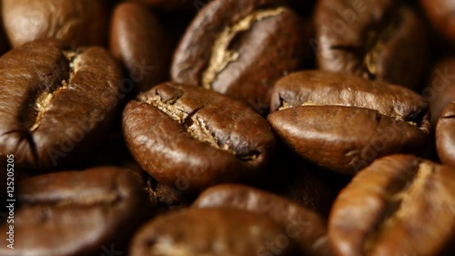 Roasted coffee beans on a table. Rotating. Close up photo