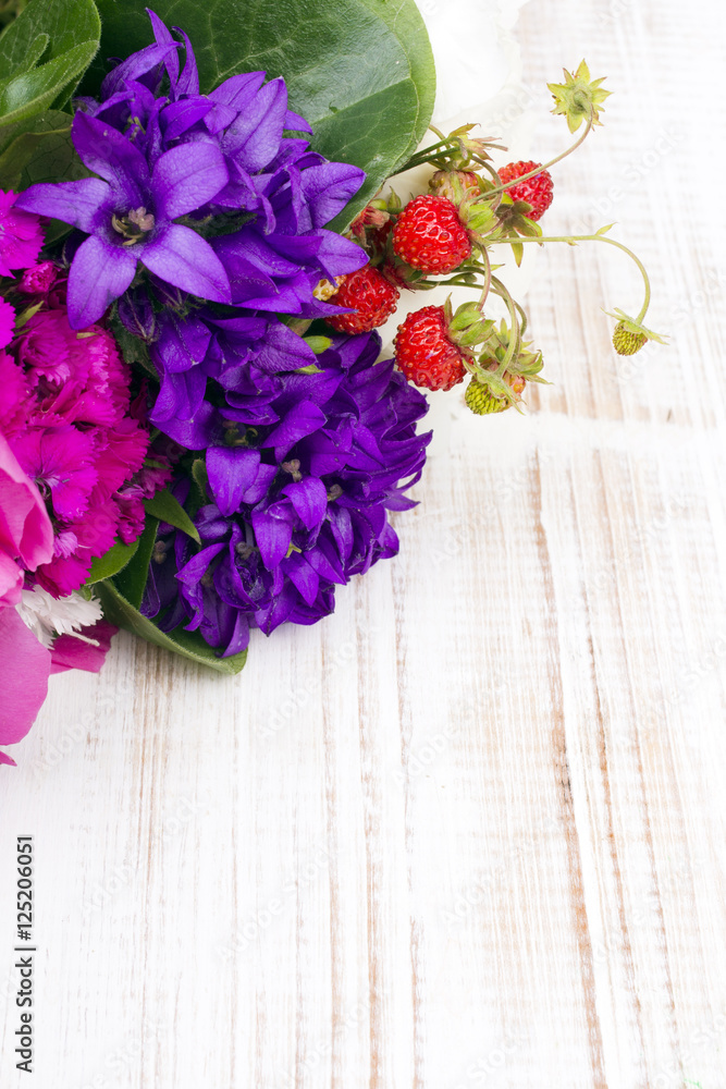 bouquet of colorful flowers on white wooden planks bouquet of colorful flowers on white wooden planks