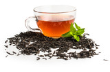 Black tea in a cup of glass. Mint and tea leaves. On white, isolated background.