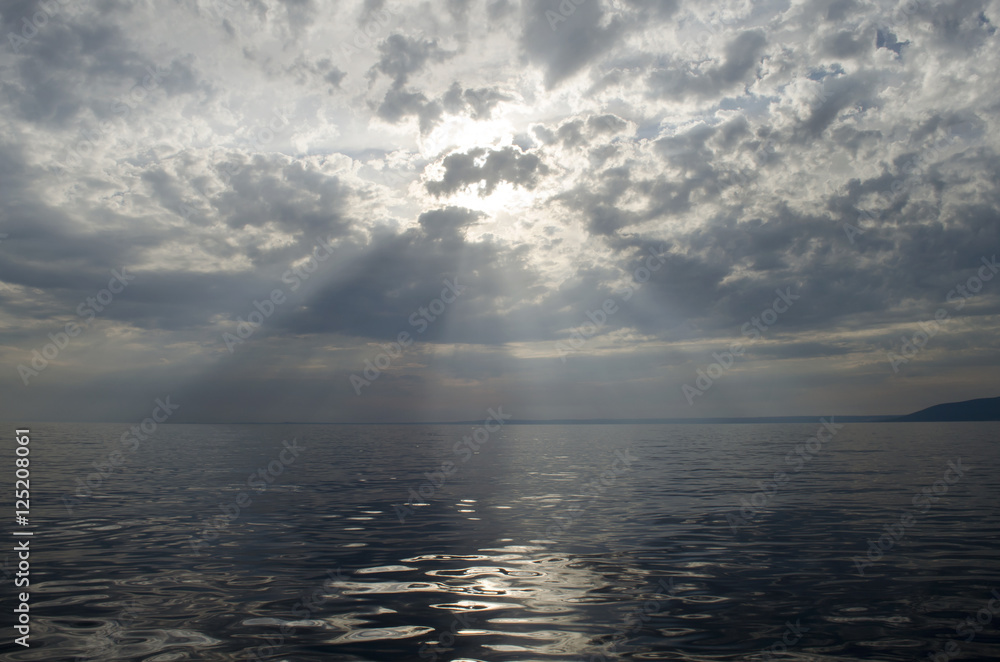 Fototapeta premium Sunrise over the sea in a cloudy sky