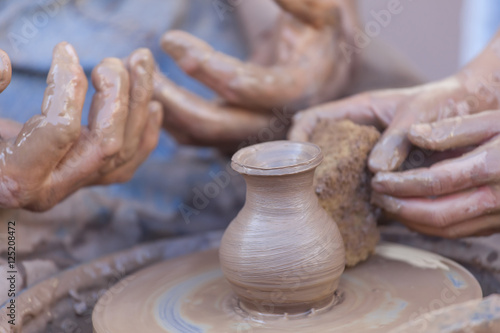 Pottery making. Close up view on hands.