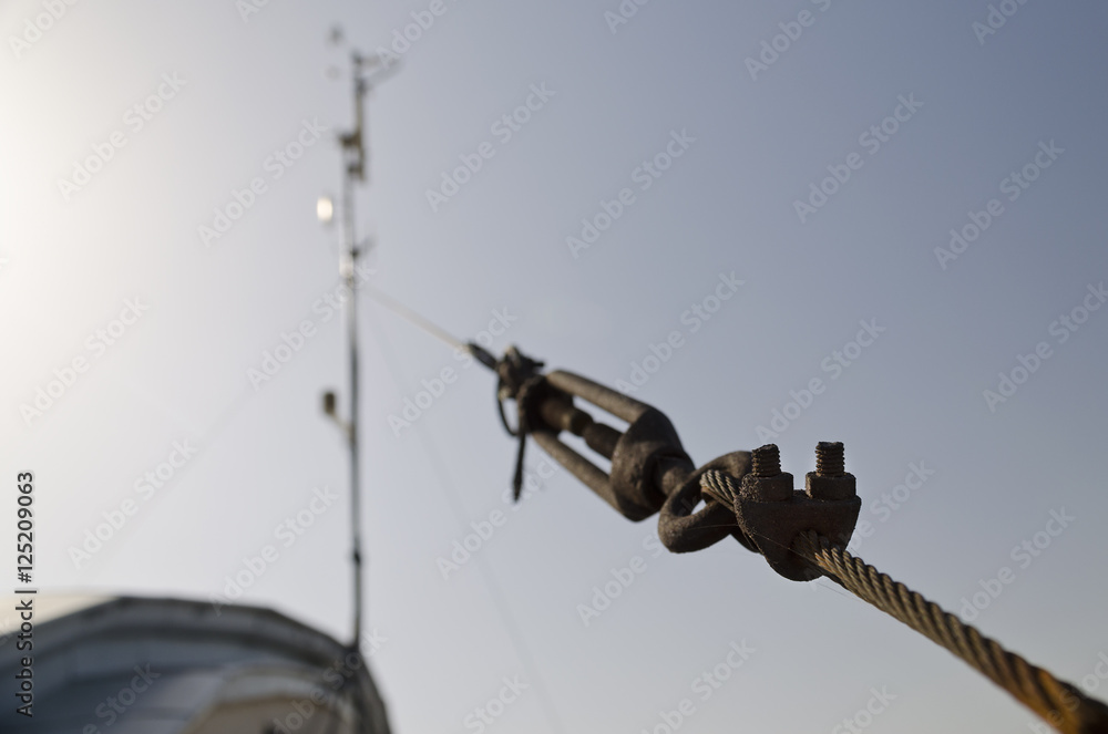 Steel turnbuckle holding hook eye with fastening and metal cables Steel turnbuckle holding hook eye with fastening and metal cables
