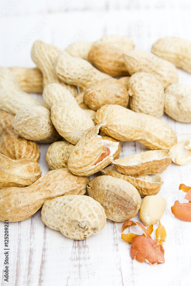 peanuts on a white wooden background peanuts on a white wooden background