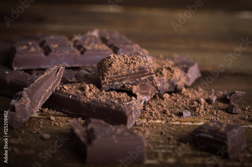 Crushed dark chocolate on a wooden table