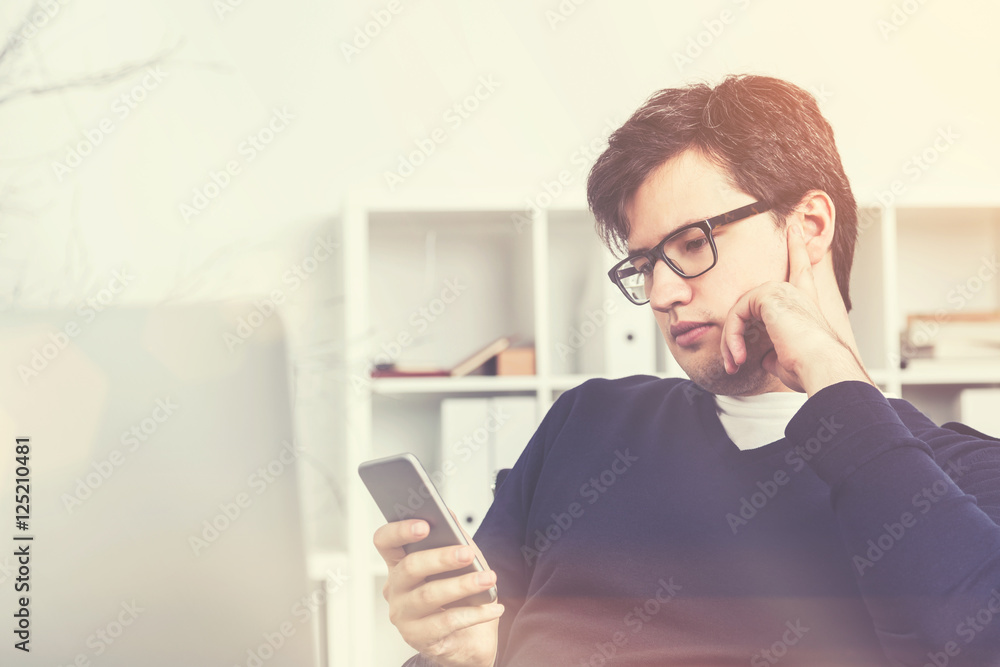 Businessman using his smartphone, toned