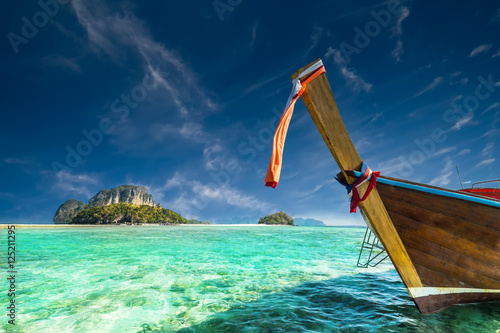 Thai traditional wooden boat with ribbon decoration at ocean shore near Koh Tup island. Thailand  Krabi province  Ao Nang