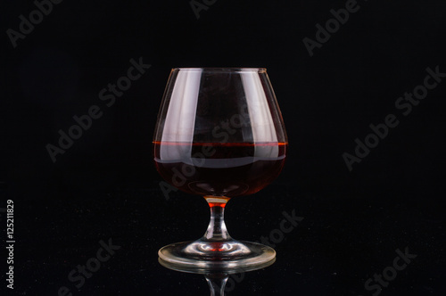 Glass of whiskey on a black background
