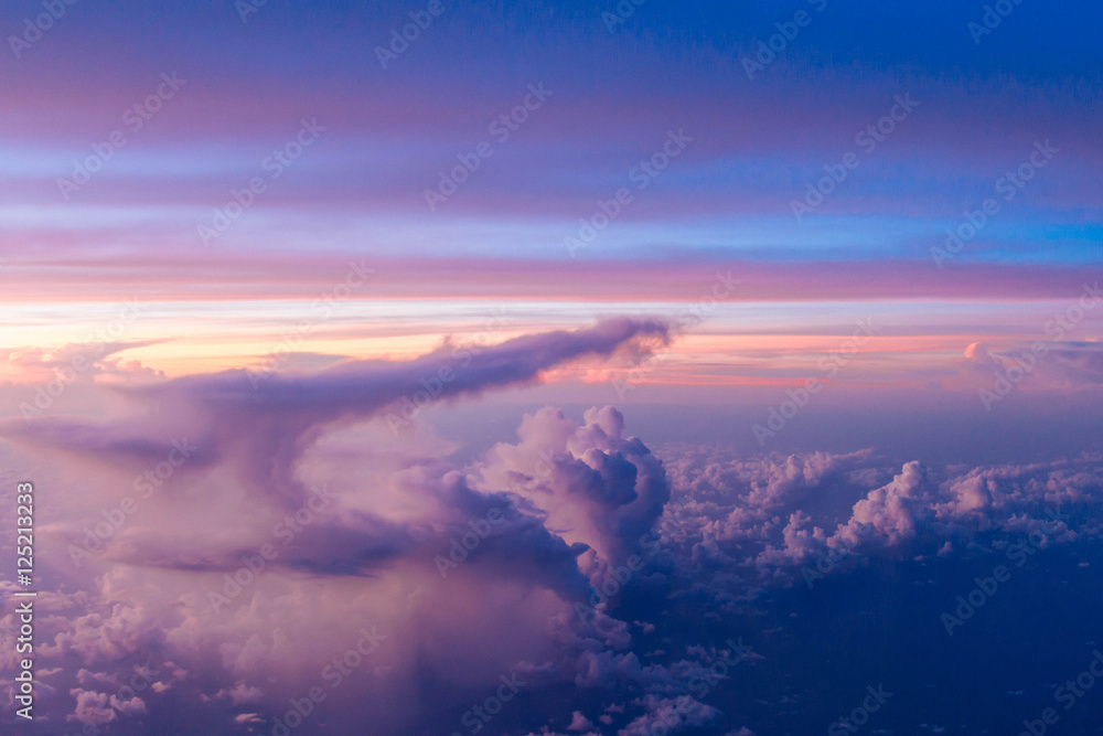 Aerial view from airplane flying above the clouds , Twilight tme