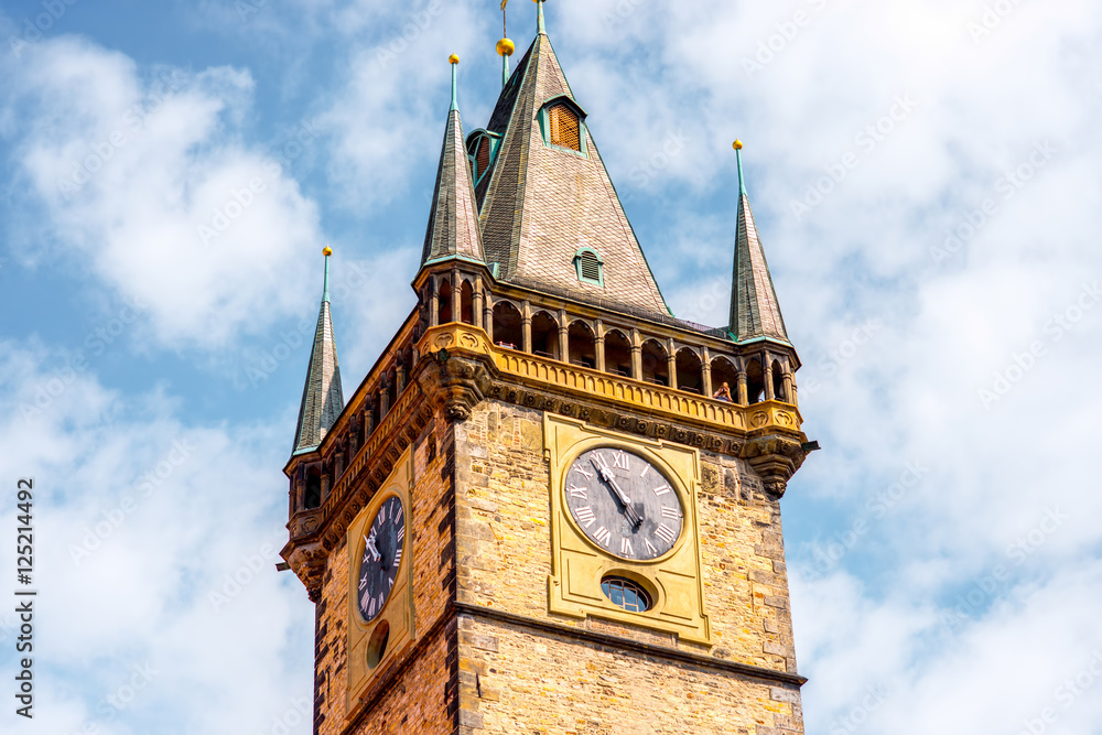 Close-up view on the clock tower on the sky background in Prague