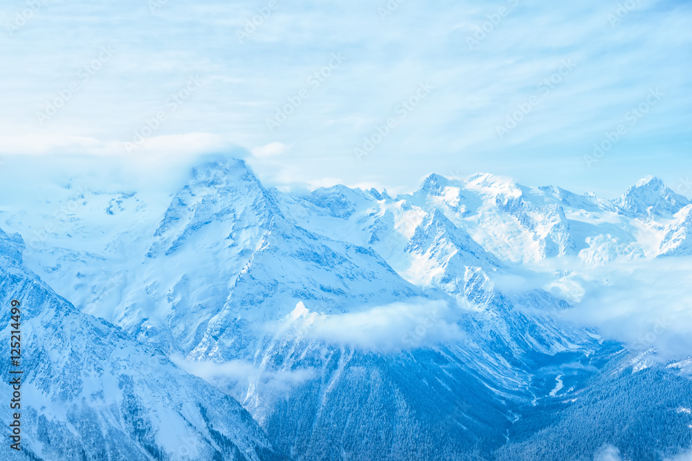 amazing view of winter day landscape Dombaj mountains with blue