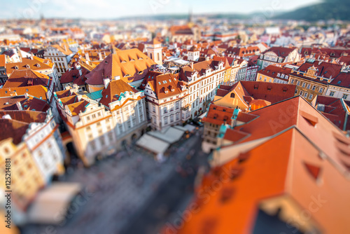 Top cityscape view on the old town square from the clock tower during the sunset in Prague. Blurred image with tilt-shift technic