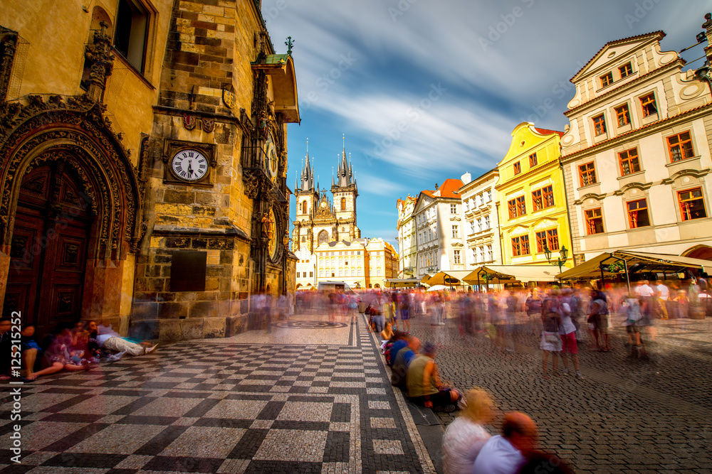View on the astronomical clock and cathedral on the old town square in Prague city. Long exposure image technic with blurred people and clouds