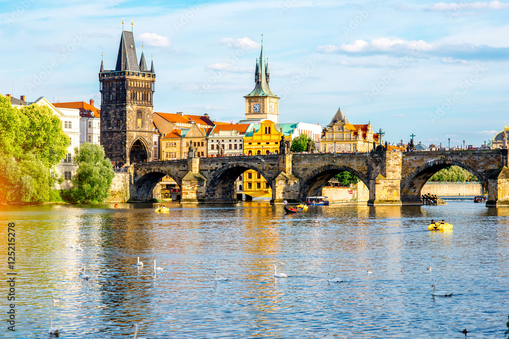 Fototapeta premium Citycsape view on the riverside with the bridge and old town in Prague