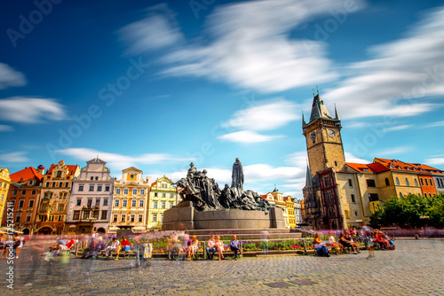 View on the old town square with the famous clock tower in Prague city. Long exposure image technic with blurred people and clouds photo