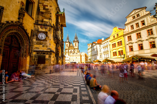 View on the astronomical clock and cathedral on the old town square in Prague city. Long exposure image technic with blurred people and clouds