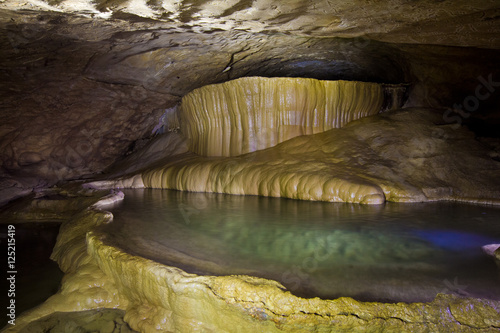 Natural speleothem, cascades of lakes and waterfalls in Nizhneshakuranskaya cave, Abkhazia, Georgia photo