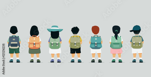 Schoolboy standing at the back of a backpack.
