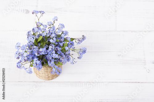 blue flowers bouquet on white wooden background