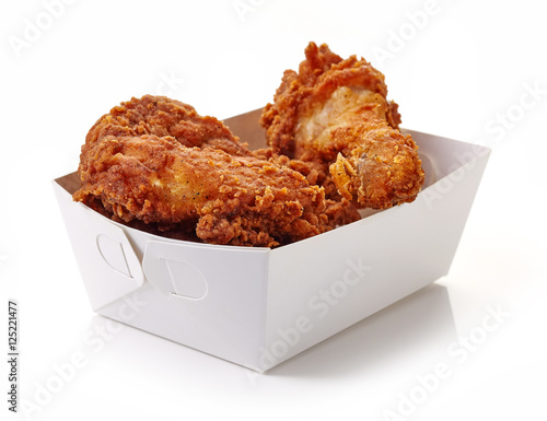 Fried breaded chicken in white cardboard box