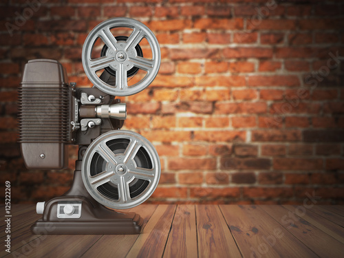 Vintage projector on the bricks background. Cinema, movie or vid