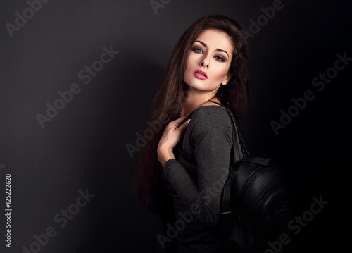 Sexy makeup woman with long hair posing with black fashion backp