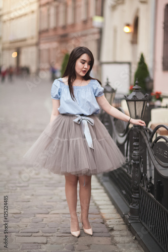 Young Asians girl with modern dress posing in an old Krakow