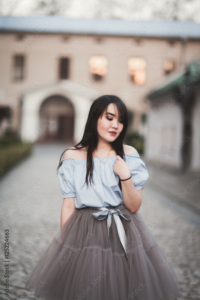 Young Asians girl with modern dress posing in an old Krakow Young Asians girl with modern dress posing in an old Krakow