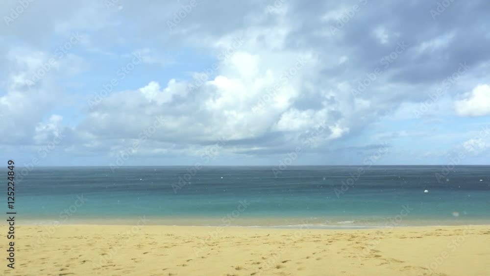 rain falling on a caribbean beach with golden sand rain falling on a caribbean beach with golden sand