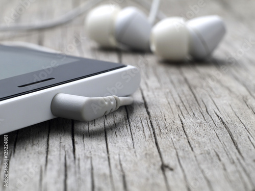 closeup of earphones mini-jack connector on smartphone, macro, shallow depth of field