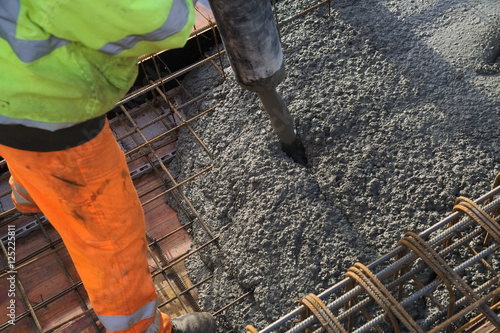 Concreting of slab pouring concrete engineering construction with rebar and formwork photo