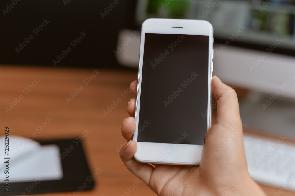 Top side view of a business person hands using smart phone, office desk background Top side view of a business person hands using smart phone, office desk background