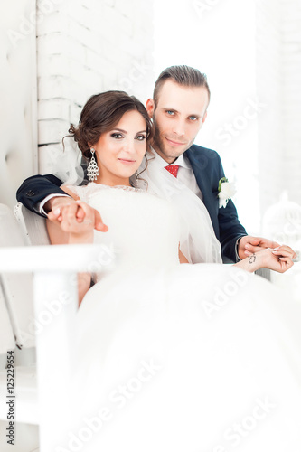 gentle bride sitting in a white room