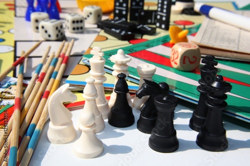 Set of table games with white and black chess pieces in the foreground