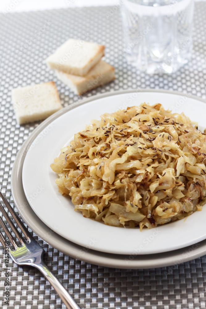 Fried cabbage with caraway and garlic on a plate Fried cabbage with caraway and garlic on a plate