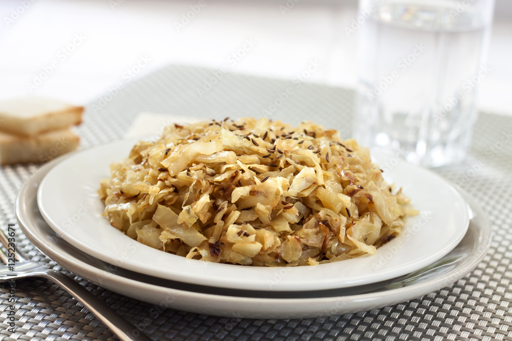 Fried cabbage with caraway and garlic on a plate