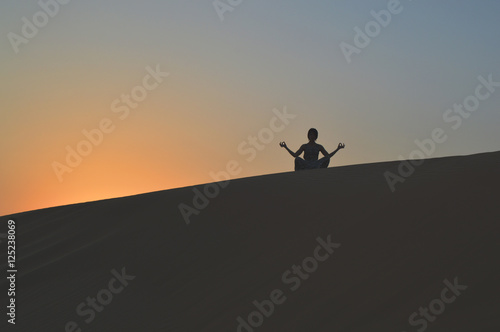 girl in the setting sun in the desert