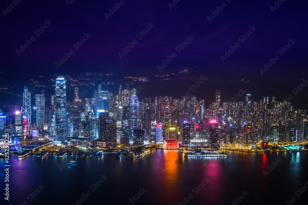 Night aerial view panorama of Hong Kong skyline and Victoria Harbor. Travel destinations Night aerial view panorama of Hong Kong skyline and Victoria Harbor. Travel destinations