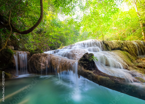 Jangle landscape with flowing turquoise water of Erawan cascade waterfall at deep tropical rain forest. National Park Kanchanaburi  Thailand