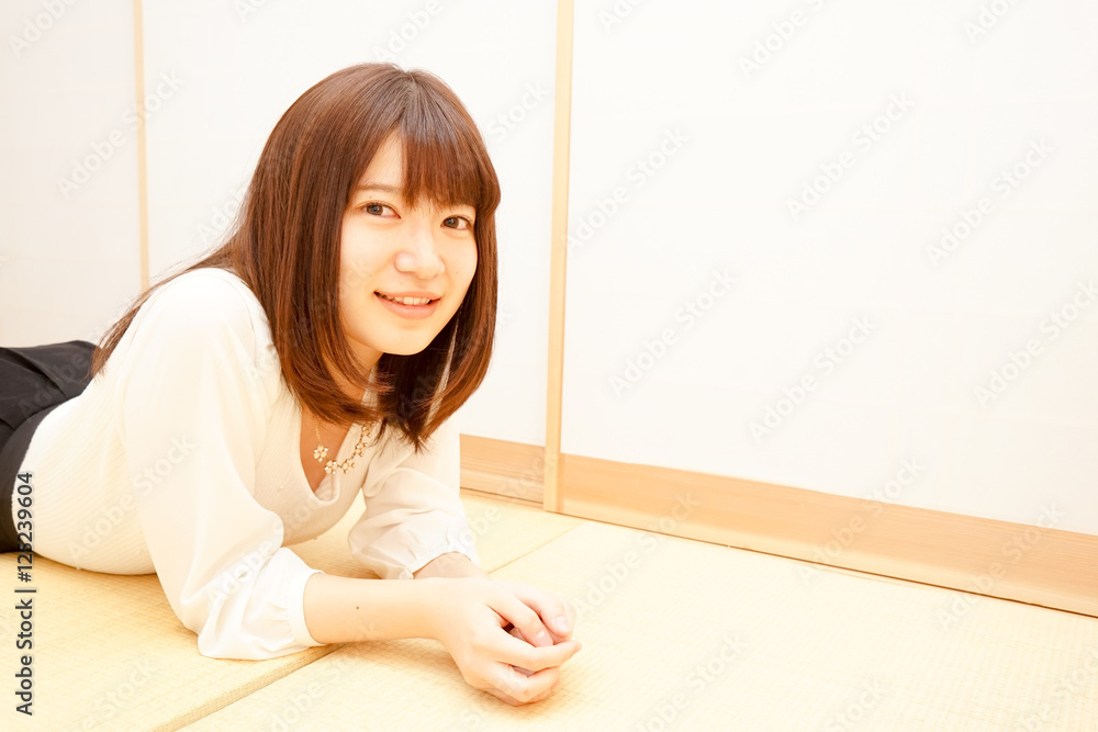 Young woman relaxing in a Japanese style room Young woman relaxing in a Japanese style room