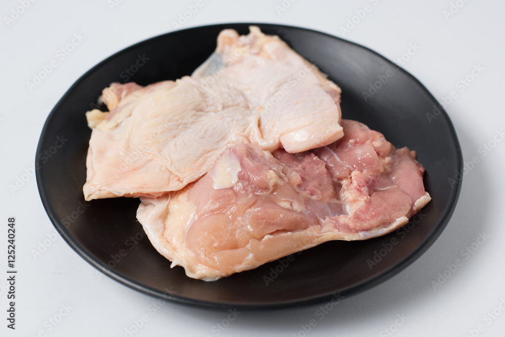 Fresh raw chicken meat on black dish Fresh raw chicken meat on black dish