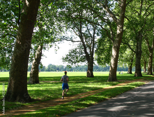 Man jogging in a park on a sunny day © Juan Gomez