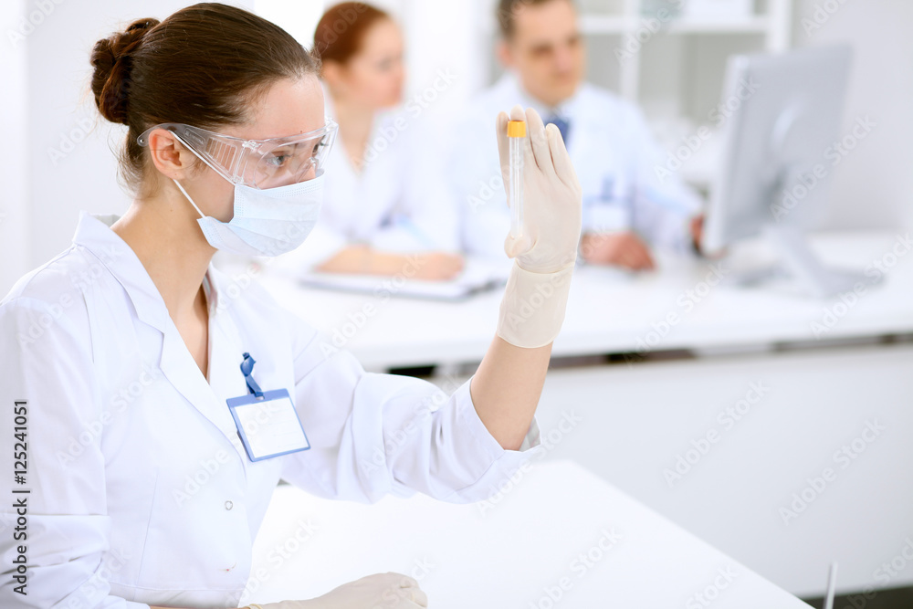 Scientific research team with clear solution in laboratory Scientific research team with clear solution in laboratory