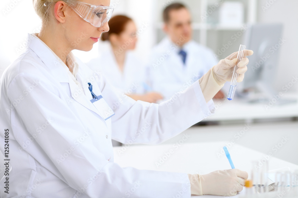 Scientific research team with clear solution in laboratory Scientific research team with clear solution in laboratory