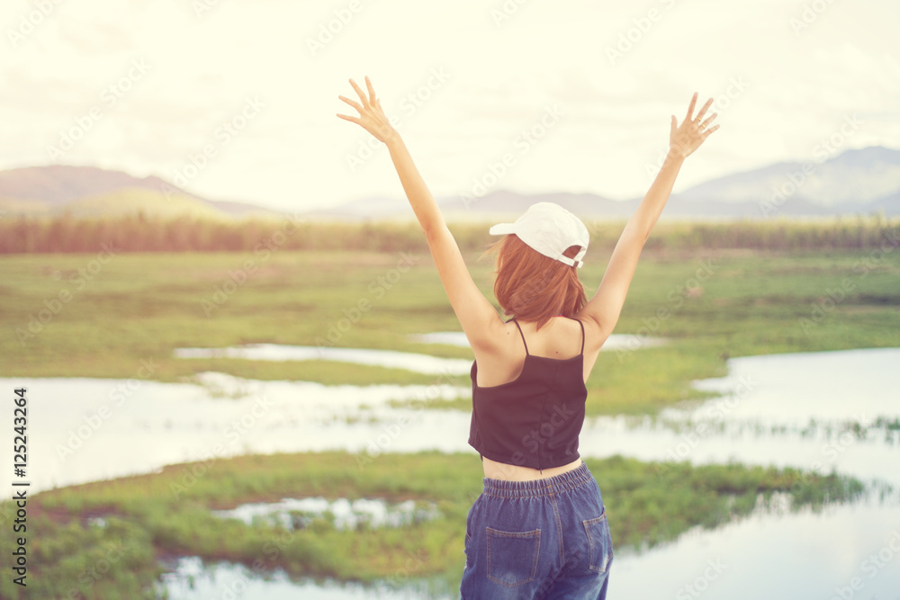 Asia girl relax in nature have mountain and water at background. Selective focus and soft flare sunlight. Asia girl relax in nature have mountain and water at background. Selective focus and soft flare sunlight.