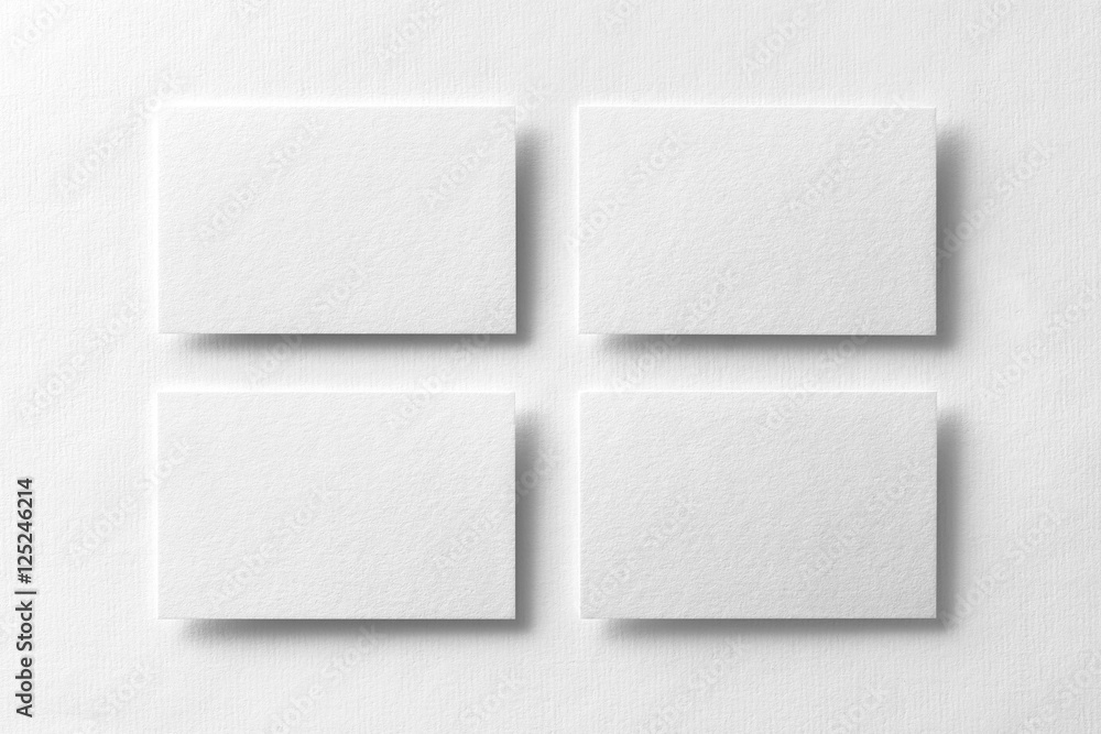 Mockup of four white business cards arranged in rows Mockup of four white business cards arranged in rows