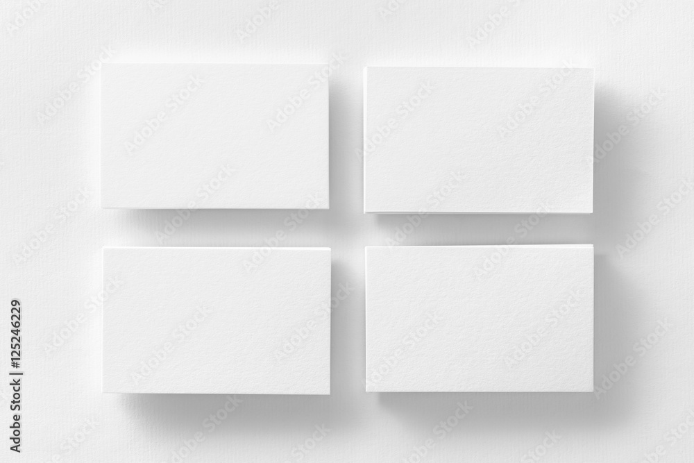 Mockup of four white business cards stacks arranged in rows Mockup of four white business cards stacks arranged in rows