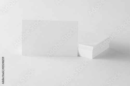 Mockup of single business card at cards stack on design paper