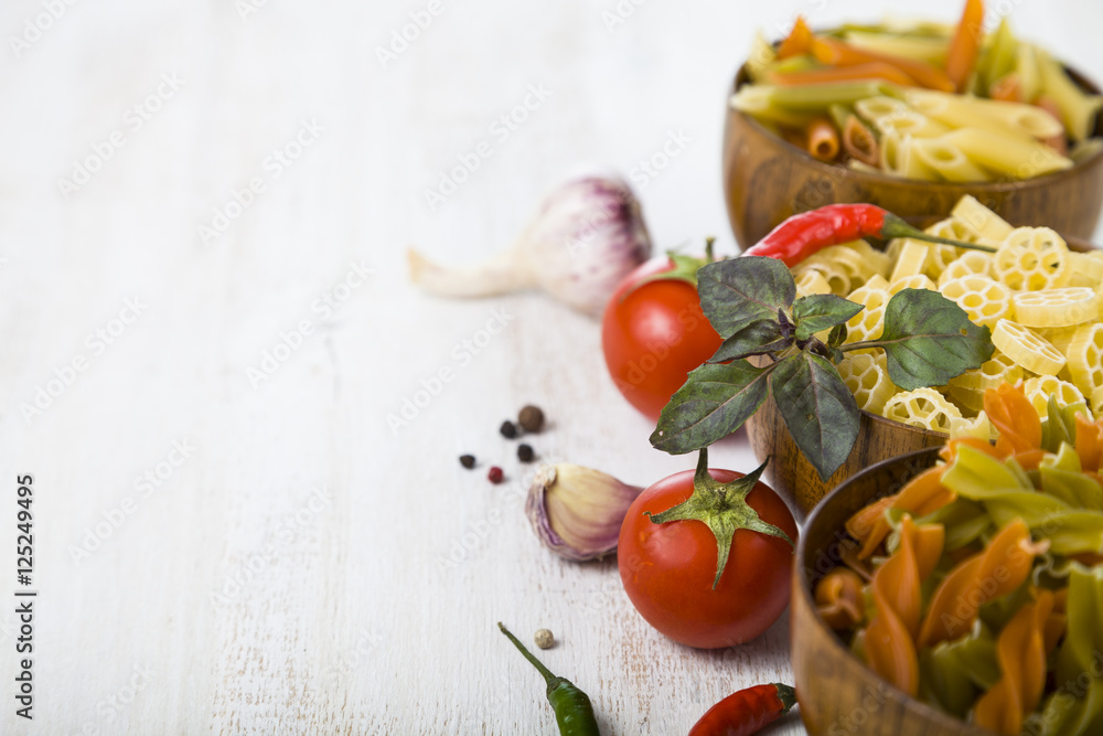 Raw pasta and spices in wooden table Raw pasta and spices in wooden table