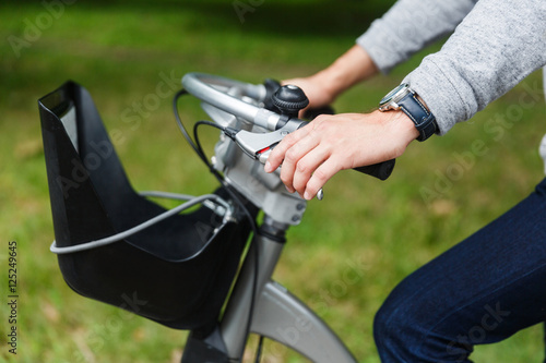 Man in casual clothing sitting on bicycle. Image without face