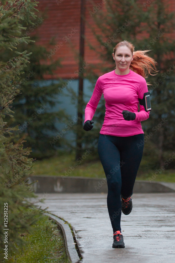 Woman in pink running in autumn park. Female runner outdoor, Healthy lifestyle Woman in pink running in autumn park. Female runner outdoor, Healthy lifestyle